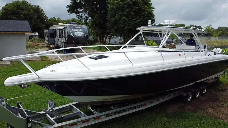  Yacht Photos Pics 2008 Intrepid 390 Sport Yacht on trailer, parked outdoors near trees and RV.