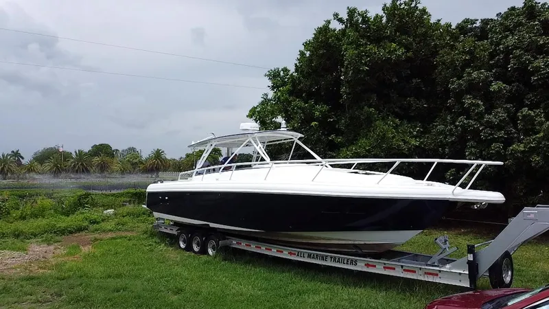  Yacht Photos Pics 2008 Intrepid 390 Sport Yacht on trailer, parked on grass near trees.