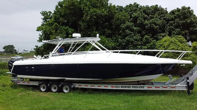  Yacht Photos Pics 2008 Intrepid 390 Sport Yacht on trailer, parked on grass, surrounded by trees.