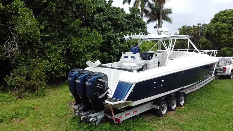  Yacht Photos Pics 2008 Intrepid 390 Sport Yacht on trailer, surrounded by lush greenery.