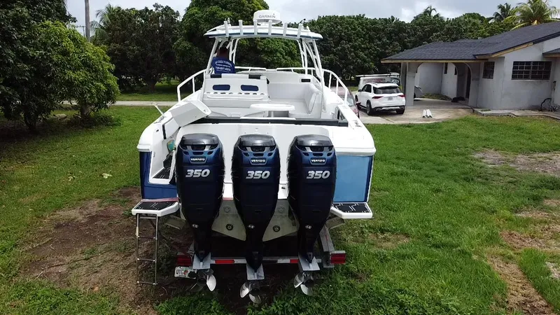  Yacht Photos Pics 2008 Intrepid 390 Sport Yacht with triple 350 engines, parked on grass near a house.