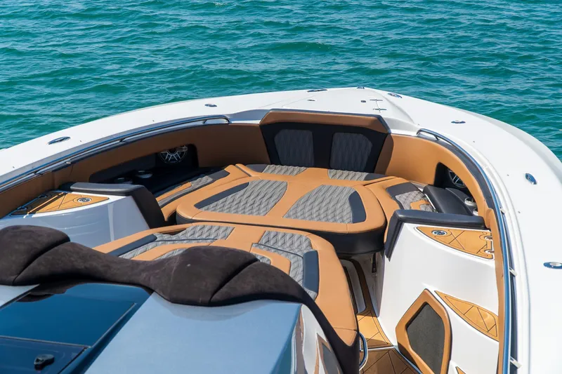  Yacht Photos Pics Luxury MTI V50 boat interior with cushioned seating, 2022 model, on clear blue water.