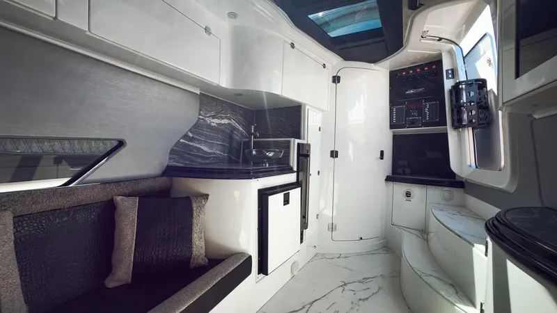  Yacht Photos Pics Luxurious interior of 2022 MTI V50 yacht with modern kitchen and seating area.