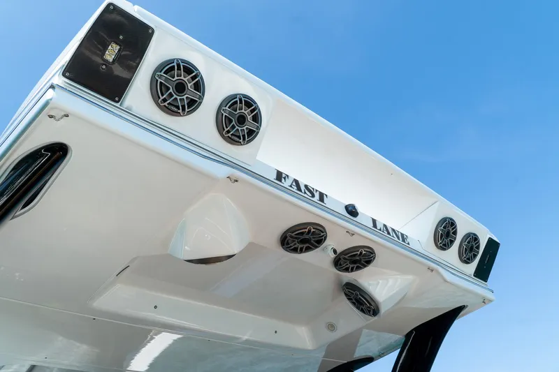  Yacht Photos Pics MTI V50 2022 boat with speakers and "Fast Lane" text against blue sky.
