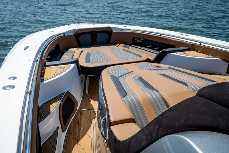  Yacht Photos Pics Luxury MTI V50 boat interior with tan and gray seating, 2022 model, on open water.