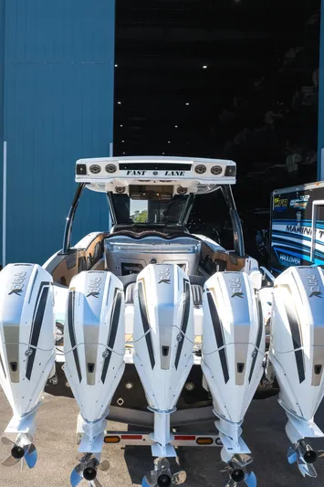  Yacht Photos Pics 2022 MTI V50 boat with four powerful outboard engines in a marina setting.