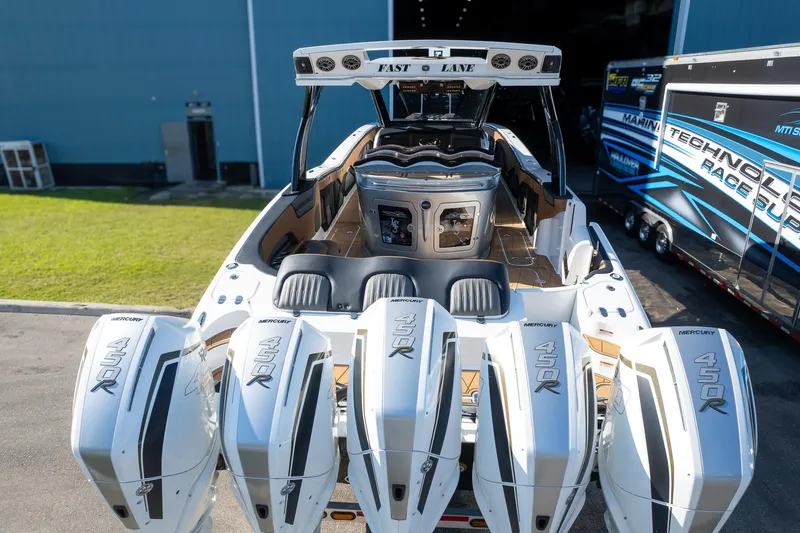  Yacht Photos Pics High-performance MTI V50 boat with quad 450R engines, 2022 model, docked near a trailer.
