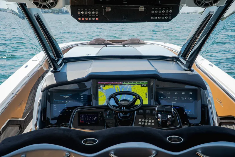  Yacht Photos Pics Cockpit of 2022 MTI V50 boat with advanced navigation screens and controls on open water.
