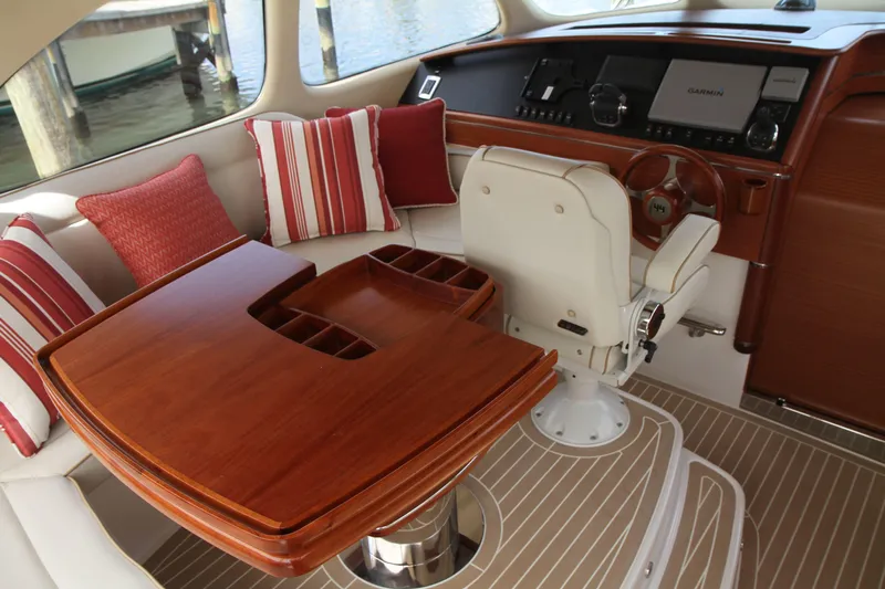 Gazelle Yacht Photos Pics Luxurious 2014 Zeelander Z44 yacht interior with elegant wood table and striped cushions.