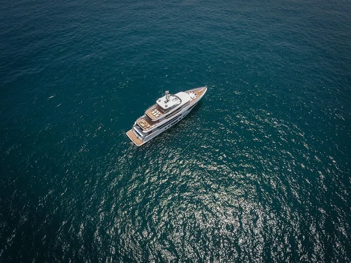  Yacht Photos Pics Aerial view of 2025 Majesty 120 yacht cruising on open ocean waters.