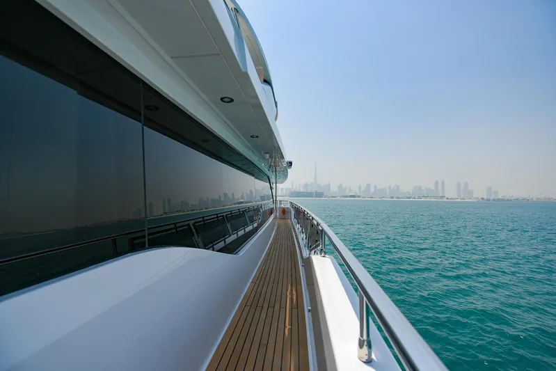  Yacht Photos Pics Luxurious Majesty 120 yacht cruising with city skyline in the background, 2025 model.