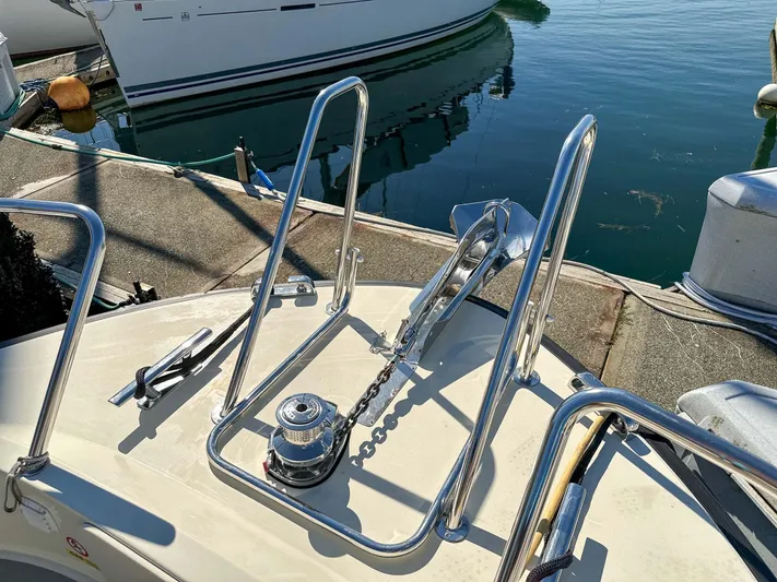  Yacht Photos Pics 2019 Targa 32 boat deck with anchor and railing in marina.