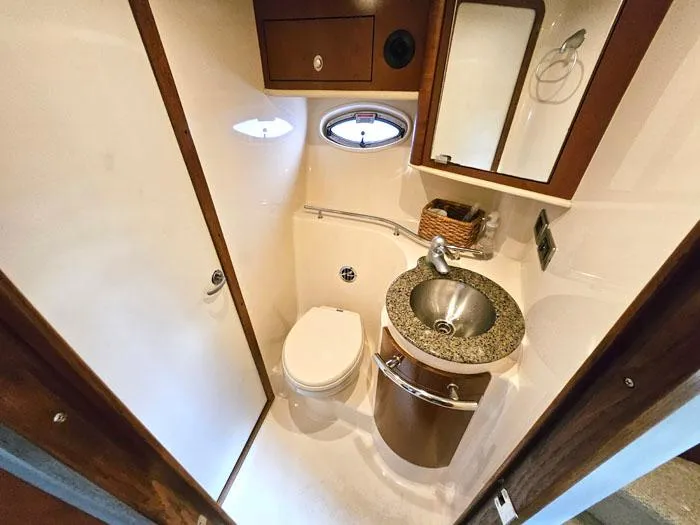  Yacht Photos Pics Luxurious bathroom in 2007 Sea Ray 40 Sundancer yacht with modern fixtures and porthole window.