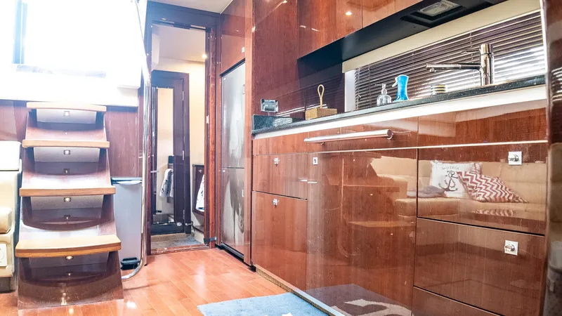 Jones'n Yacht Photos Pics Luxurious interior of 2009 Sea Ray 470 Sundancer yacht with modern kitchen and wooden stairs.