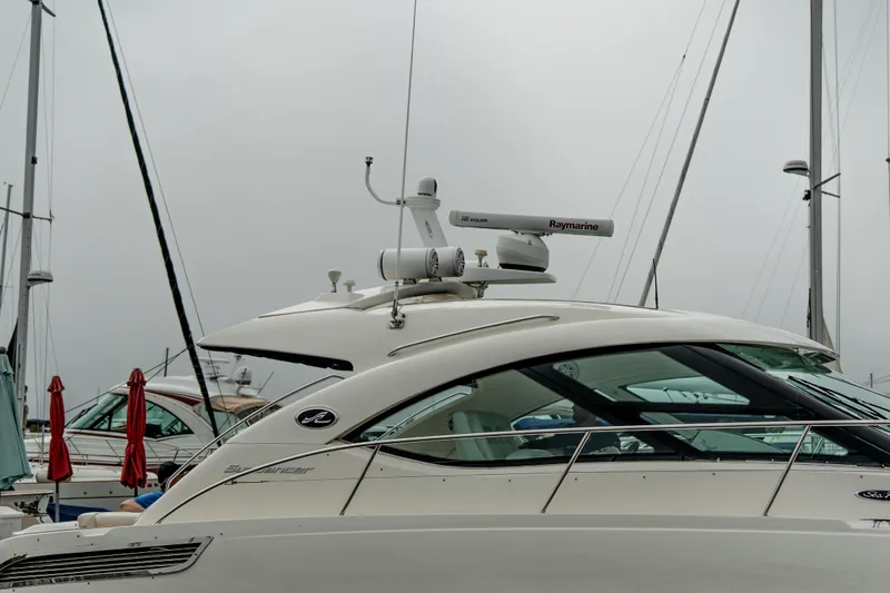 Jones'n Yacht Photos Pics 2009 Sea Ray 470 Sundancer yacht docked at marina, overcast sky.