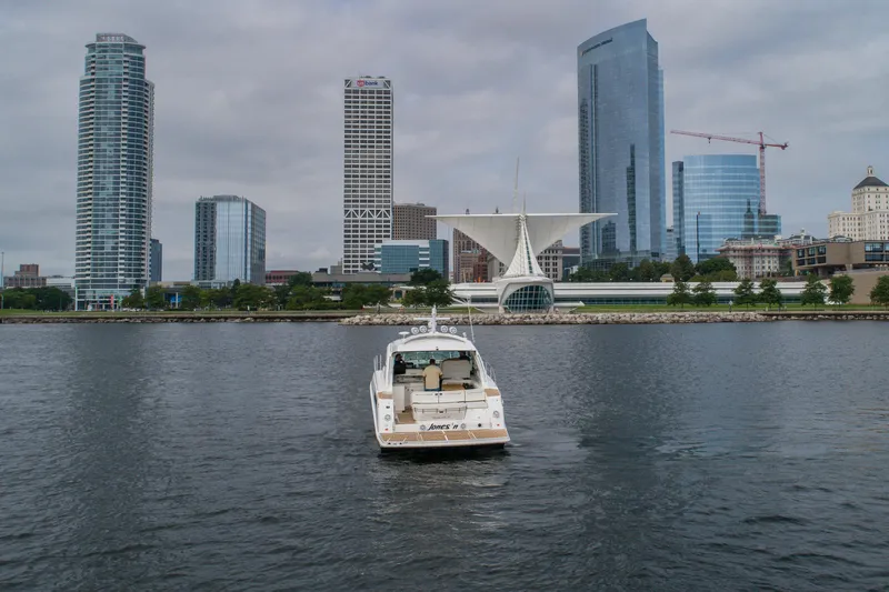 Jones'n Yacht Photos Pics Sea Ray 470 Sundancer yacht on water with city skyline in background, 2009 model.