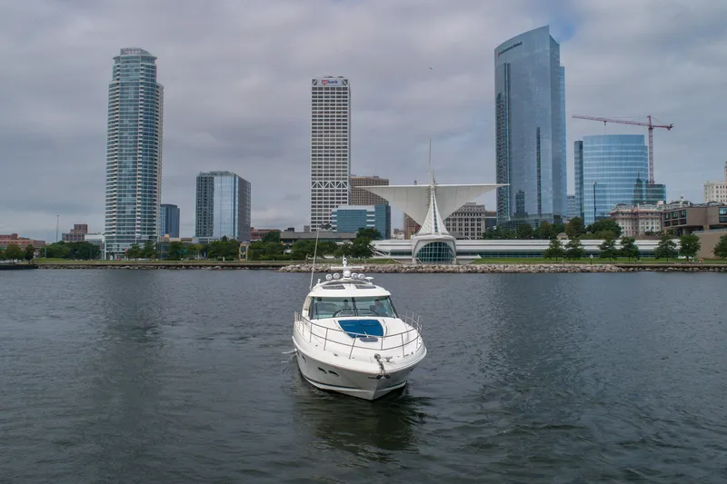 Jones'n Yacht Photos Pics 2009 Sea Ray 470 Sundancer yacht on water with city skyline backdrop.