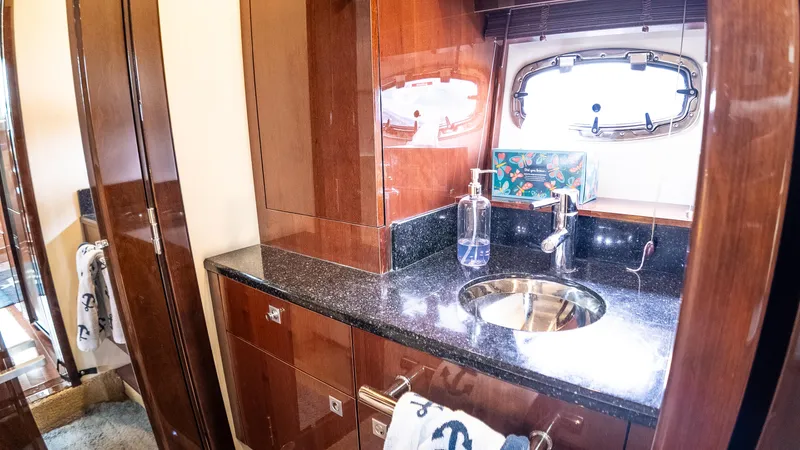 Jones'n Yacht Photos Pics Luxurious bathroom interior of 2009 Sea Ray 470 Sundancer yacht with sleek wood finish.