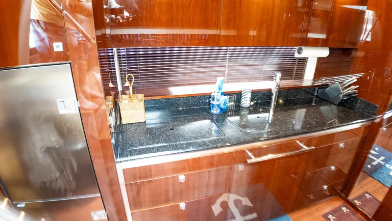 Jones'n Yacht Photos Pics Luxurious kitchen area in 2009 Sea Ray 470 Sundancer yacht with sleek wood cabinetry.