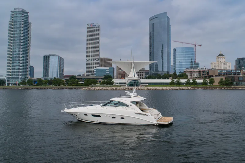 Jones'n Yacht Photos Pics 2009 Sea Ray 470 Sundancer yacht on urban waterfront with skyscrapers in background.