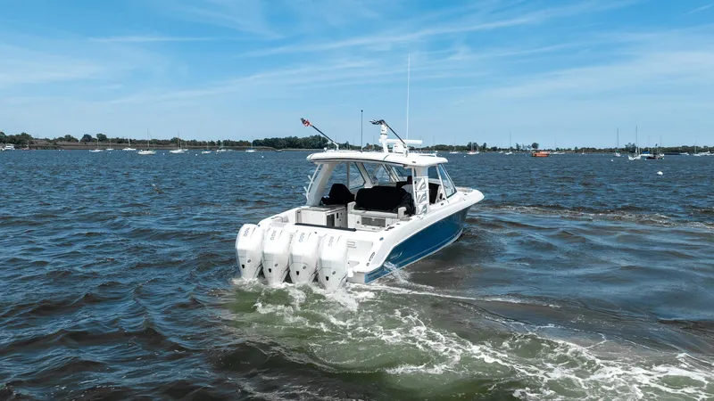  Yacht Photos Pics 2020 Boston Whaler 38 Realm cruising on open water under a clear blue sky.