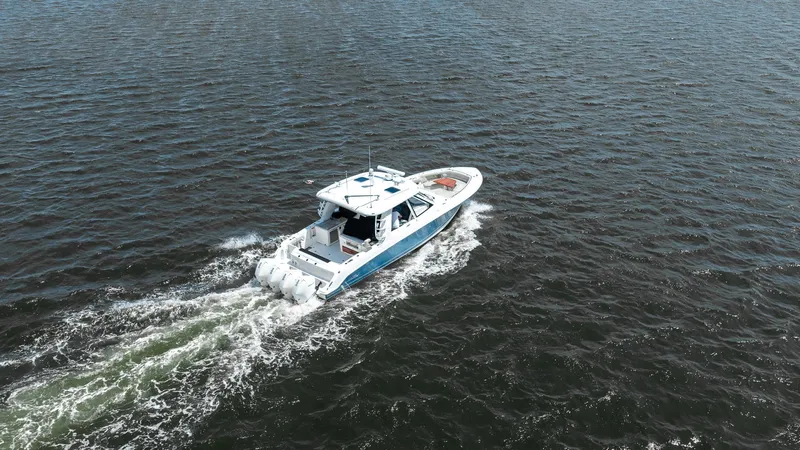  Yacht Photos Pics 2020 Boston Whaler 38 Realm cruising on open water, aerial view.