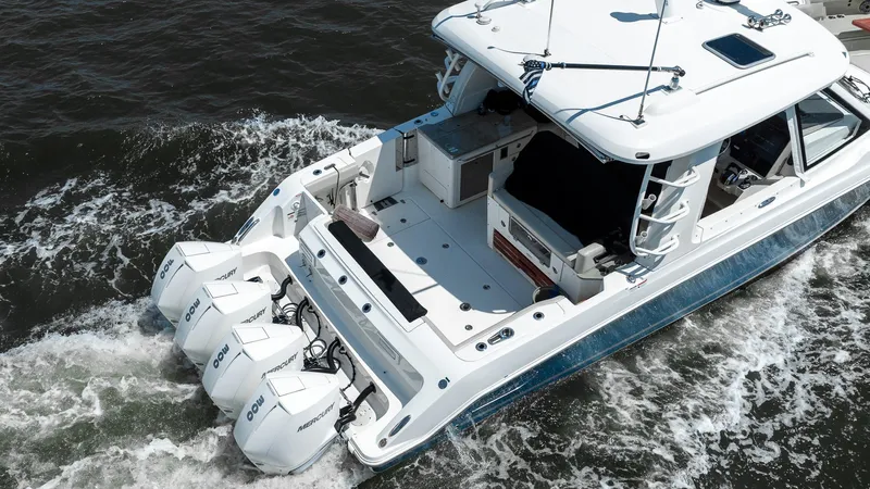  Yacht Photos Pics 2020 Boston Whaler 38 Realm cruising on water with triple outboard engines.