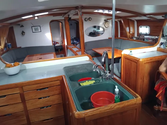 Atanahoue Yacht Photos Pics Interior of a 2000 Custom Paladin 60 yacht with wooden cabinetry and modern kitchen amenities.