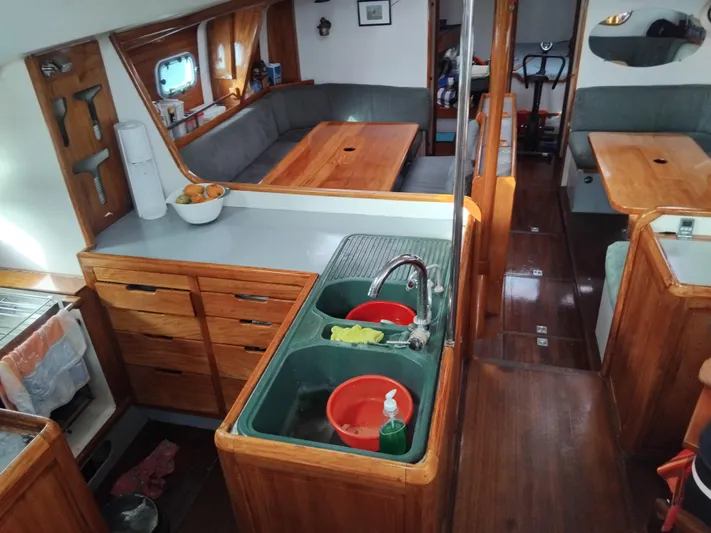 Atanahoue Yacht Photos Pics Interior of a 2000 Custom Paladin 60 yacht with wooden cabinetry and seating area.