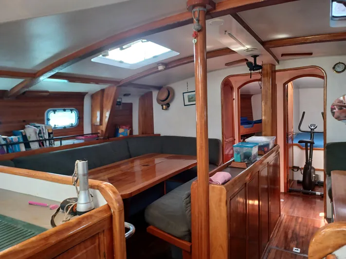 Atanahoue Yacht Photos Pics Interior of a 2000 Custom Paladin 60 yacht with wooden furnishings and cozy seating area.