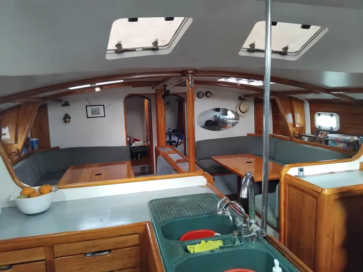 Atanahoue Yacht Photos Pics Interior of 2000 Custom Paladin 60 yacht with wooden furnishings and skylights.