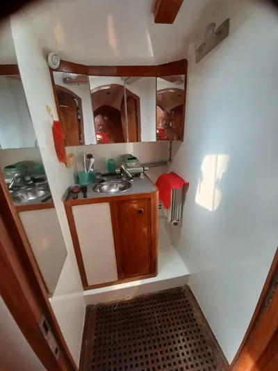 Atanahoue Yacht Photos Pics Compact bathroom in a 2000 Custom Paladin 60 yacht, featuring wooden cabinetry and stainless steel sink.