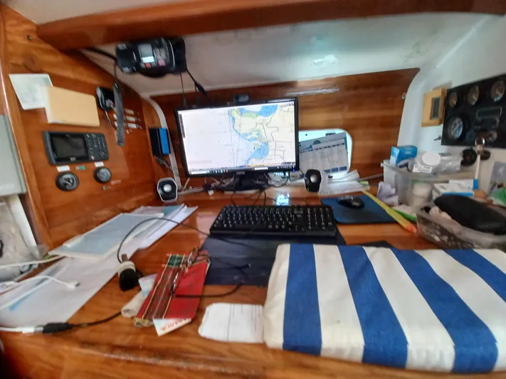 Atanahoue Yacht Photos Pics Navigation station on Custom Paladin 60 yacht with maps and computer setup, year 2000.