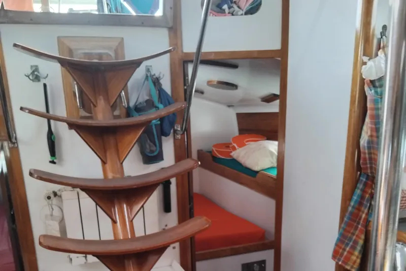 Atanahoue Yacht Photos Pics Interior of a 2000 Custom Paladin 60 yacht with wooden stairs and cozy cabin.