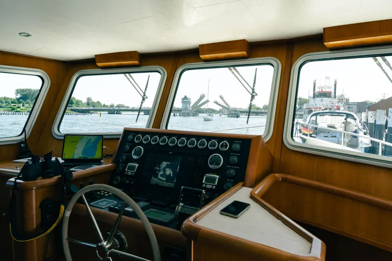  Yacht Photos Pics Pilothouse view of 2011 Privateer Trawler 50 with open bridge in background.