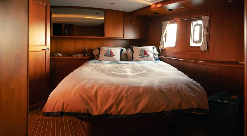  Yacht Photos Pics Luxurious cabin interior of 2011 Privateer Trawler 50 with cozy bed and wooden finish.