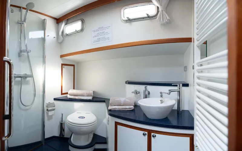  Yacht Photos Pics Luxurious bathroom in 2011 Privateer Trawler 50 yacht, featuring modern fixtures and elegant design.