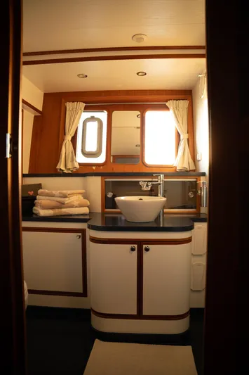  Yacht Photos Pics Luxurious bathroom in 2011 Privateer Trawler 50 yacht with elegant wood accents and modern fixtures.