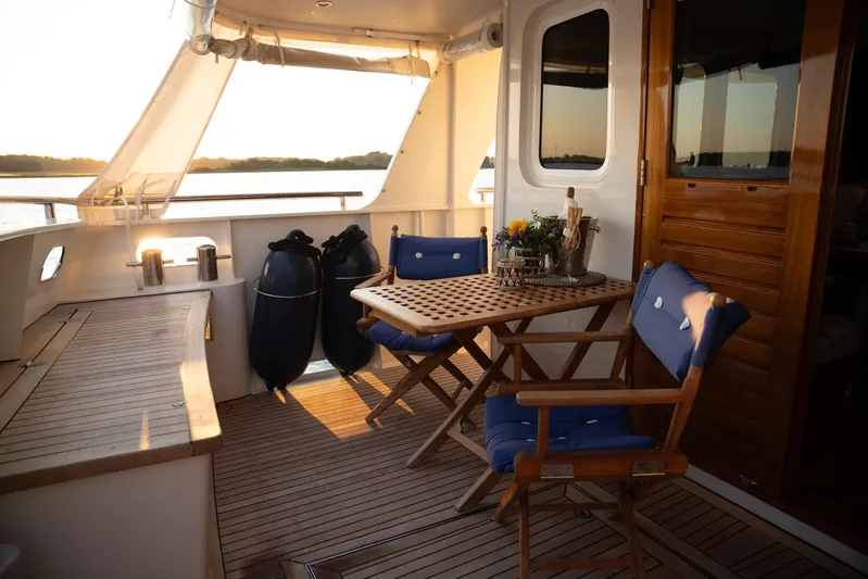  Yacht Photos Pics Privateer Trawler 50 yacht deck with wooden furniture, 2011 model, sunset view.