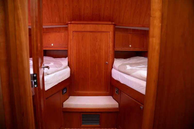  Yacht Photos Pics Cabin interior of 2011 Privateer Trawler 50 with twin beds and wooden finish.