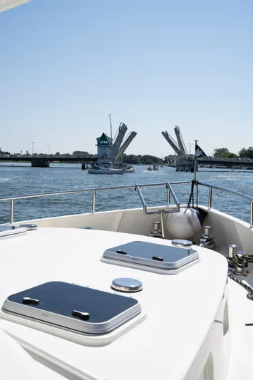  Yacht Photos Pics Privateer Trawler 50 (2011) navigating towards an open drawbridge on a sunny day.