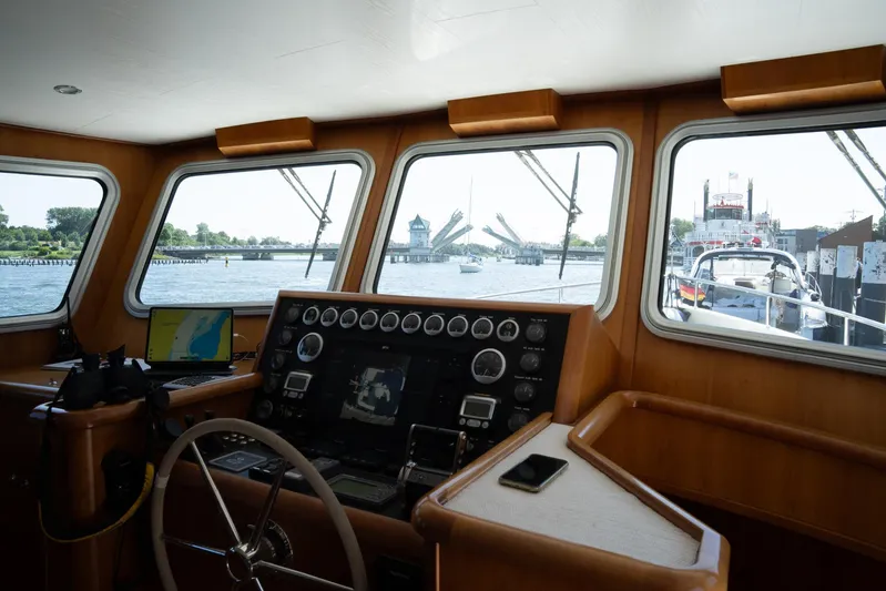  Yacht Photos Pics Interior view of 2011 Privateer Trawler 50's helm with navigational equipment and scenic waterway.