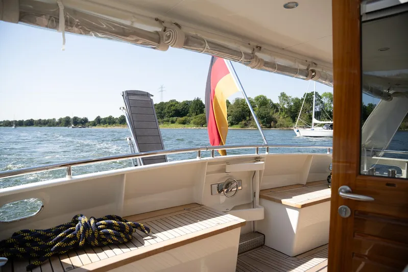  Yacht Photos Pics Privateer Trawler 50 yacht deck with flag, cruising on a sunny day, 2011 model.