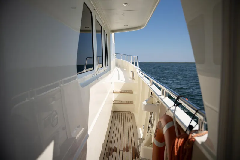  Yacht Photos Pics Side deck of 2011 Privateer Trawler 50 yacht with ocean view and life preserver.
