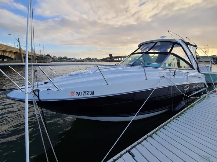  Yacht Photos Pics 2018 Monterey 295 Sport Yacht docked by a scenic waterfront.