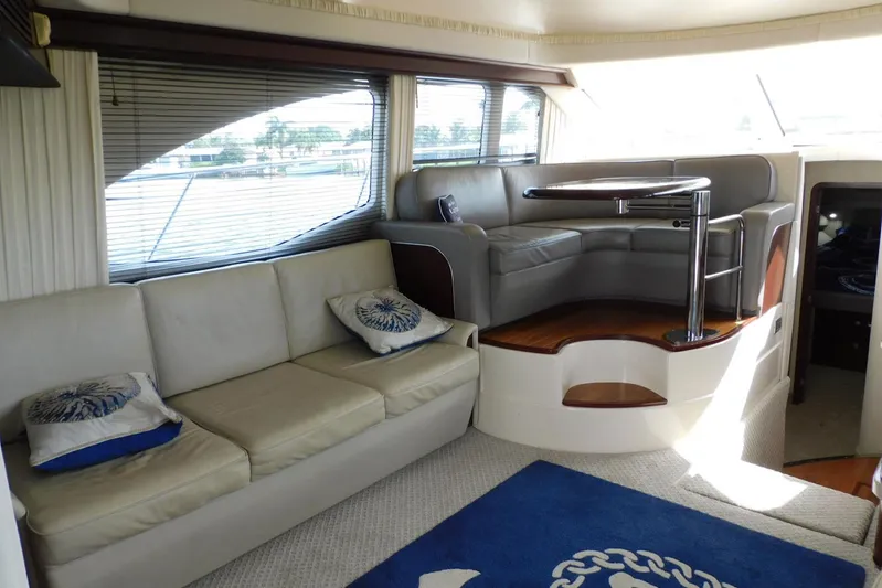Full Deck Yacht Photos Pics Luxurious interior of 2008 Sea Ray 44 Sedan Bridge yacht with plush seating and elegant decor.