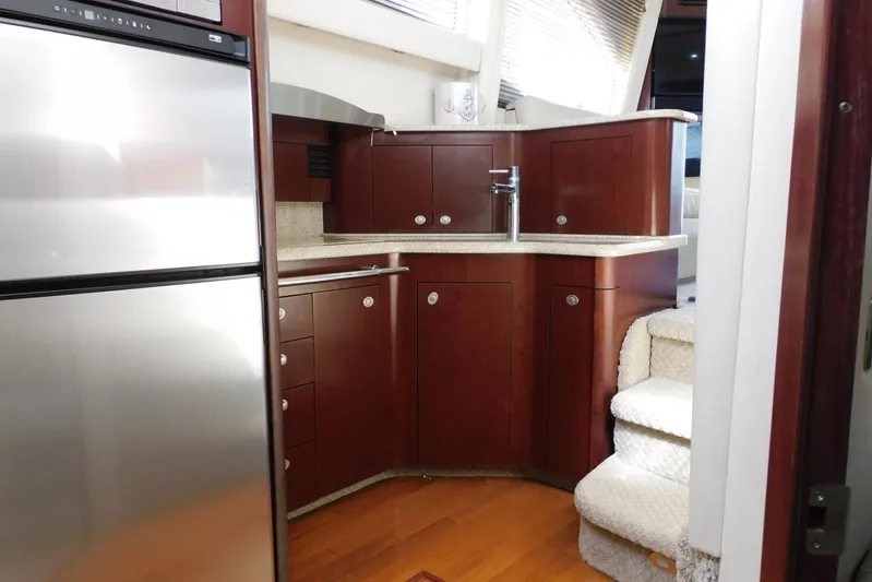 Full Deck Yacht Photos Pics 2008 Sea Ray 44 Sedan Bridge interior with modern kitchen and wooden cabinetry.
