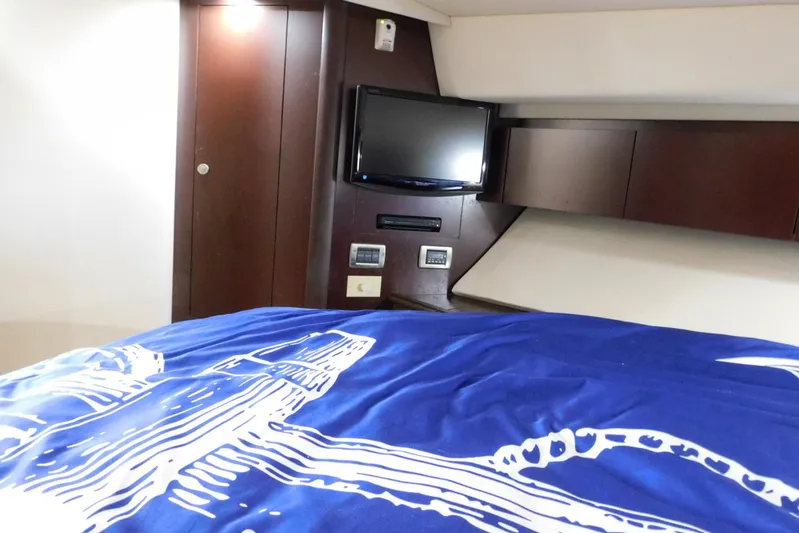 Full Deck Yacht Photos Pics Interior of 2008 Sea Ray 44 Sedan Bridge with TV and blue bedding.