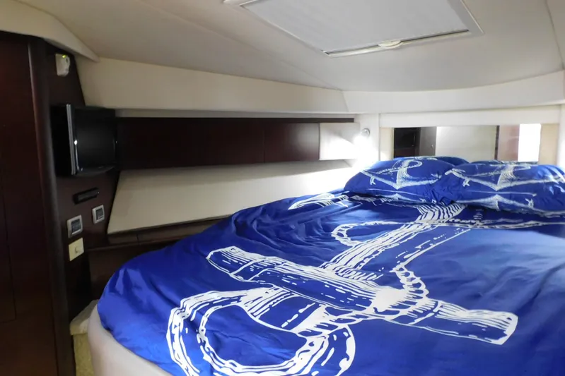 Full Deck Yacht Photos Pics Luxurious bedroom interior of 2008 Sea Ray 44 Sedan Bridge yacht with nautical-themed bedding.