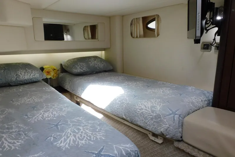 Full Deck Yacht Photos Pics Interior of 2008 Sea Ray 44 Sedan Bridge with twin beds and nautical decor.